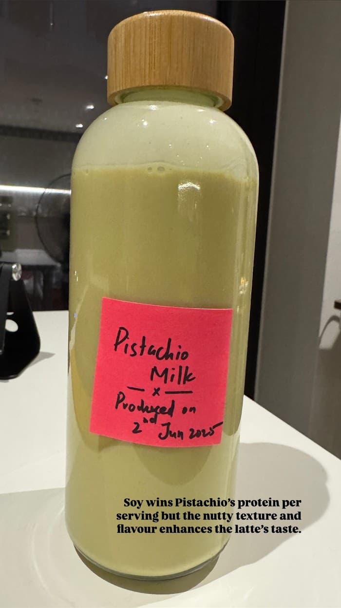 A bottle of homemade pistachio milk beside a handwritten note