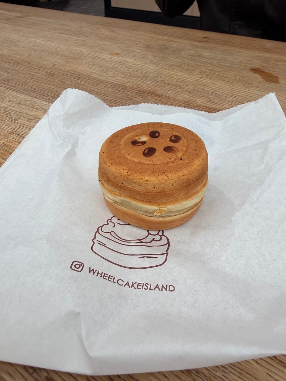 A freshly made wheel cake on its paper wrapper